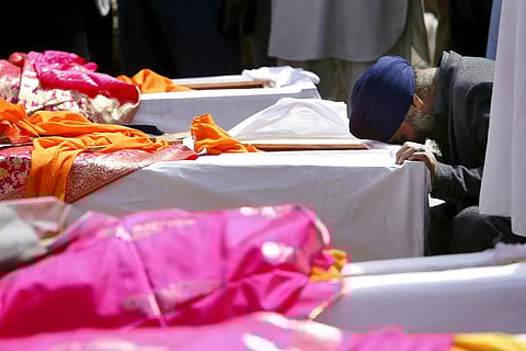 Afghan Sikh man mourns over a coffin during a funeral procession and cremation ceremony for those who were killed by IS terrorist attack inside a Gurudwara in Kabul (File | AP)
