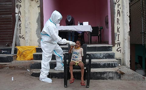 A health worker takes a nasal swab sample for COVID- 19 testing through rapid antigen kits in New Delhi. (Photo | Shekhar Yadav, EPS)