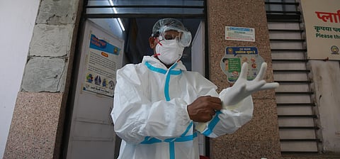 A health worker suits up to collects samples for rapid antigen based Covid-19 testing at a testing Centre in New Delhi. (Photo | Shekhar Yadav, EPS)