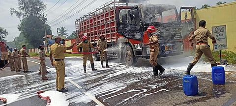 Fire and Rescue Service personnel douse the flames after a truck carrying LPG cylinders caught fire at Beero para in Ernakulam district on Thursday