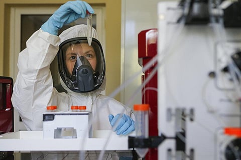 In this handout photo taken on Thursday, Aug. 6, 2020, and provided by Russian Direct Investment Fund, an employee shows a new vaccine. (Photo | AP)