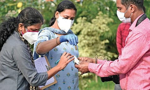 Forensic experts collect spent cartridges from the DJ Halli police station premises in Bengaluru on Thursday after violence rocked the area two nights ago | vinod kumar t