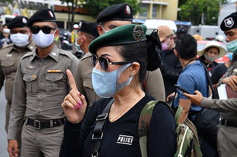 An anti-government protester dressed as a policewoman gestures at a pro-democracy protest in Bangkok. (Photo| AFP)