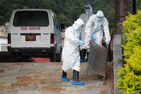 Nepalese army personnel prepare to unload from a hearse van, the body of a person who died of COVID-19 for cremation in Kathmandu, Nepal, Monday, Aug. 17, 2020. (Photo | AP)