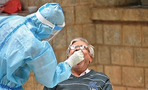An elderly man gives his sample for testing at a clinic. (Photo | Meghana Sastry/EPS)