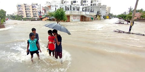 Children on Warangal streets with flood water. (Photo | EPS)