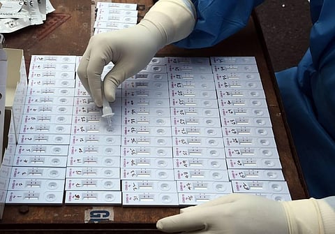 A healthcare worker collects samples for rapid antigen tests in New Delhi (Photo | Parveen Negi, EPS)