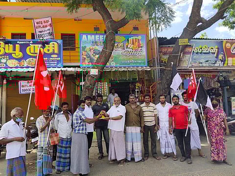 Communist party men distributing sweets to the public at Udangudi in Thoothukudi district.