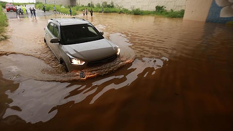 Vehicle wades through a waterlogged under pass near NH48 during heavy rainfall in New Delhi. (Photo | Shekhar Yadav, EPS)