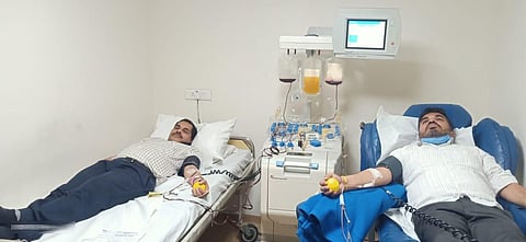 Kunigal MLA Dr H D Ranganath and his older brother Dr Ramachandra Prabhu donating plasma at HCG Cancer Centre in Bengaluru on Wednesday (Photo | Express)