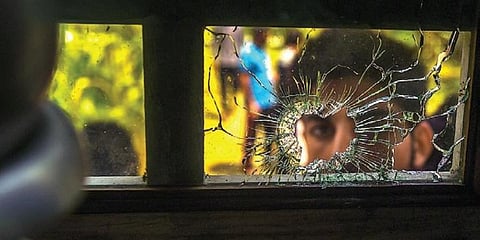 A broken window glass from a bullet hole after an encounter between security forces and militants at Ranbirgarh near Srinagar last Saturday. (Photo | PTI)