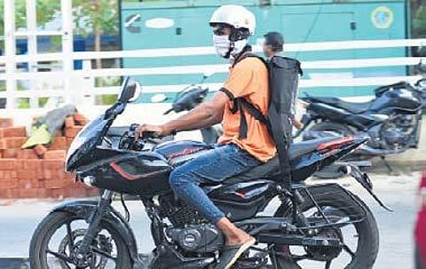 A Swiggy delivery boy wears a mask on his way to deliver food. (Photo | B P Deepu, EPS)