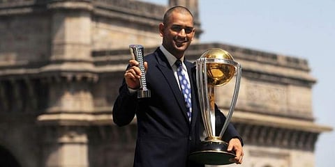 MS Dhoni poses with the Man of the Match and the ICC Cricket World Cup trophy. (File | AFP)