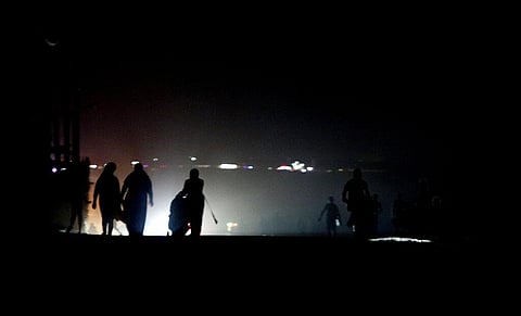 Palestinian residents walk in the Shati refugee camp in west Gaza City as the coastal enclave gets maximum four hours of electricity a day, Wednesday. (Photo | AP)