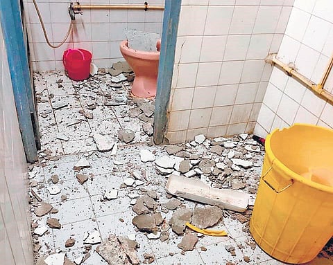 Bits of the roof which chipped off and fell in the washroom at Cardiology Duty Medical Officer’s cabin in Quli Qutub Shah block of OGH on Thursday | Express