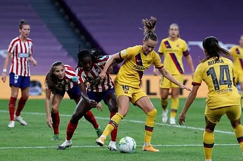 Barcelona forward Caroline Graham Hansen (C-R) challenges Atletico Madrid defender Aissatou Tounkara (C-L) during the Women's Champions League quarter-final football match (Photo | AFP)