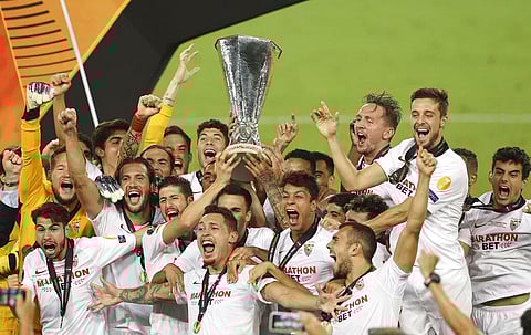 Sevilla players celebrate with the trophy after winning the Europa League final soccer match between Sevilla and Inter Milan (Photo | AP)
