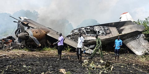 People stand near the cargo plane belonging to a local operator that crashed seven kilometres west of the Juba International airport in South Sudan. (Photo| AFP)