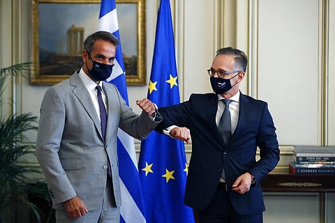 Greece's Prime Minister Kyriakos Mitsotakis, left, and Germany's foreign minister Heiko Maas touch elbows during their meeting at Maximos Mansion in Athens (Photo | AP)