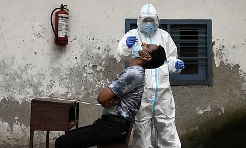 A health worker takes smaples for Covid-19 rapid antigen tests at a testing center in New Delhi on Sunday. (Photo | Parveen Negi/EPS)