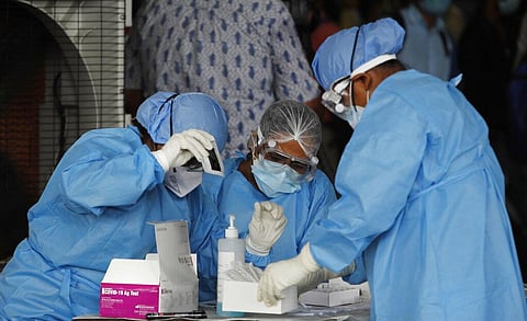 Health workers conduct COVID-19 antigen tests. (Photo | PTI)