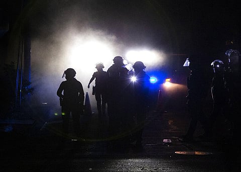 A march on the Portland police union headquarters drew a rapid police response after someone set a fire next to the building. (Photo | AP)