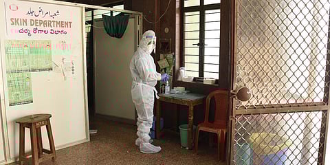 A technician in PPE getting ready to take COVID-19 tests at Unani hospital in the Old city of Hyderabad on Tuesday. (Photo| RVK Rao, EPS)