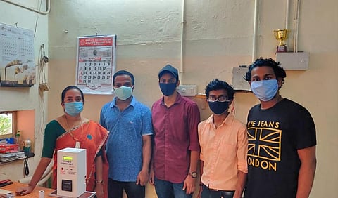 Vidya Academy students hand over the token dispenser to Dr Shabna of the Government Medical College, Thrissur