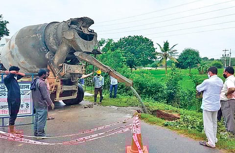 Workers fill a 12-ft-deep pit formed near a pipeline that takes Godavari water to Mallannasagar reservoir, at Yellareddypet village of Thoguta mandal on Thursday