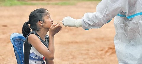 A young girl gives her nasal swab for testing in Bengaluru | meghana Sastry