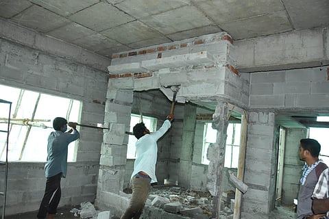 GHMC workers demoliting an illegal 6th floor building near NMDC Mehidipatnam in hyderabad on Thursday. (Photo | R V K Rao, EPS)