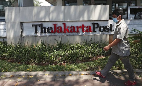 A man walks in front of the Jakarta Post newspaper building (Photo | AP)