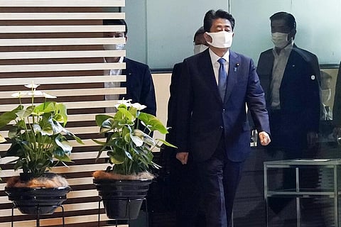Japan's Prime Minister Shinzo Abe, right, walks at prime minister's office in Tokyo. (Photo | AP)