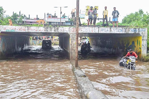 Commuters move through a waterlogged underpass after heavy rainfall in Bhopal Saturday Aug 29 2020. (Photo | PTI)