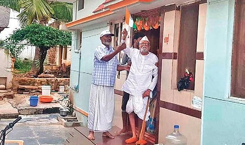 Venkosa Bhandage waves the Tricolour at his home in Gadag district after he tested Covid-negative | EXPRESS