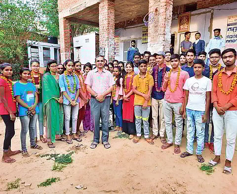 Deshraj Varma with his students who performed well in the recent Class X board examinations at Jhalana Doongri | Express
