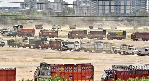 Trucks move slowly in a queue at Burari, during the ongoing nationwide COVID-19 lockdown, in New Delhi. (File Photo)