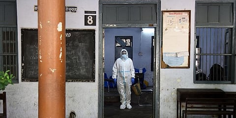 A health worker wearing PPE before conducting COVID-19 antigen tests. (Photo | Parveen Negi, EPS)