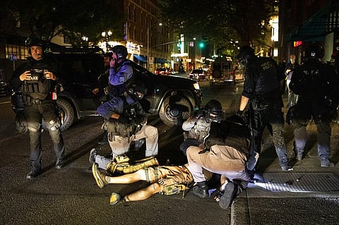 A man is treated by medics after being shot Saturday in Portland after fights broke out as a large caravan of Trump supporters drove throuh the city clashing with counter-protesters. (Photo | AP)