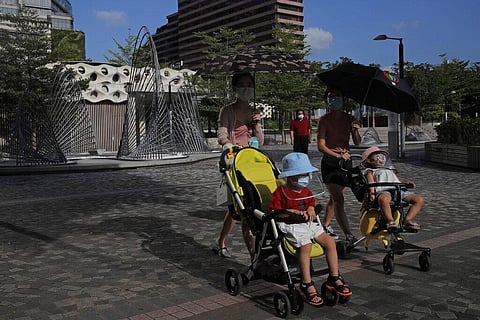 People wearing masks to protect against the coronavirus, walk at a park in Hong Kong, Thursday, Aug. 20, 2020. (Photo | AP)