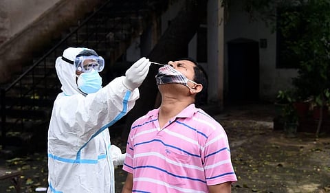 A health worker collects swab samples for COVID-19 Rapid Antigen detection test. (Photo | Parveen Negi/EPS)