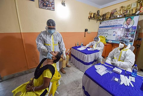 A health worker collects sample of a woman for COVID-19 test via Rapid Antigen Testing in Kolkata Monday Aug 3 2020. (Photo | PTI)