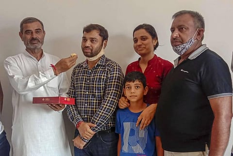 Pradeep Singh who got the first rank in the Civil Services Exams 2019 being offered sweets by his father-in-law at their residence in Sonipat Tuesday Aug 4 2020. (Photo | PTI)