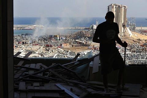 A man stands in a damaged apartment as he looks out at the scene of a massive explosion that hit the seaport of Beirut, Lebanon. (Photo | AP)