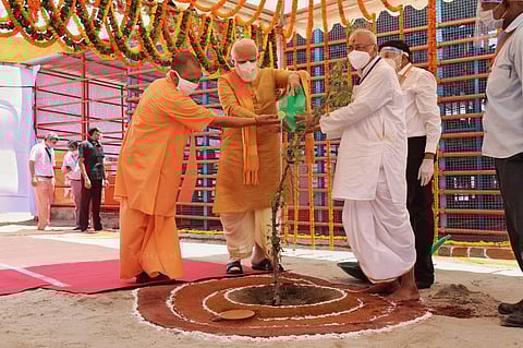 UP chief minister along with PM Modi planting a parijat sapling at the Ram Temple site (Photo | Express)