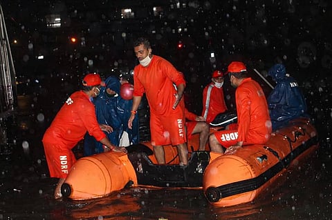 NDRF personnel rescue passengers from a local train stranded between Masjid Bunder and Byculla stations on the Central line during heavy rain in Mumbai Wednesday Aug. 5 2020. (Photo | PTI)
