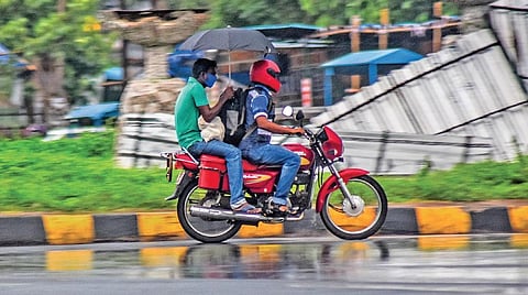 Commuters braving a sudden downpour in Bhubaneswar I EXPRESS