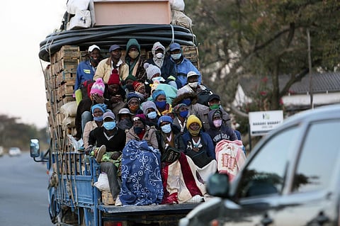 An open truck carries farmers wearing face masks on the first day of the curfew in Harare, Wednesday, July, 22, 2020. (Photo | AP)