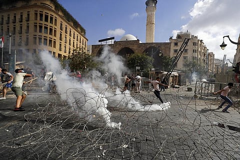 People clash with police during a protest against the political elites and the government after this week's deadly explosion at Beirut port. (Photo | AP)