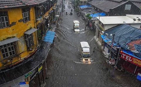 Vehicles ply on a waterlogged street during heavy rains at Byculla area in Mumbai. (Photo | PTI)